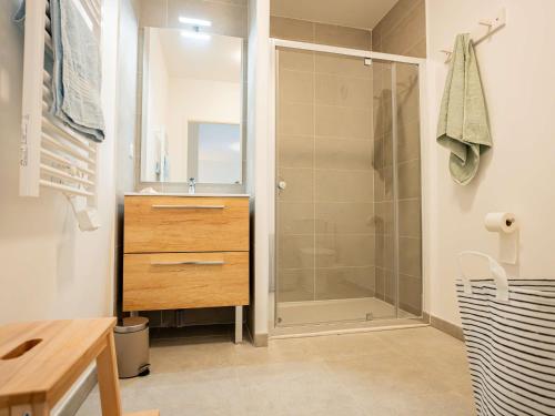 a bathroom with a shower and a sink and a mirror at Bel Appartement T2 Neuf avec Terrasse - FR-1-553-292 in Balaruc-les-Bains