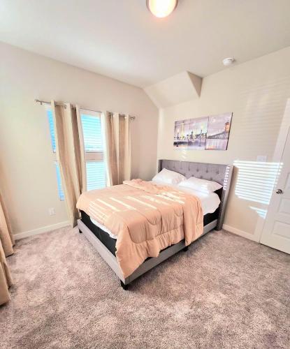 a bedroom with a bed in a room with windows at Serene 4BR Retreat In Forney, TX in Forney