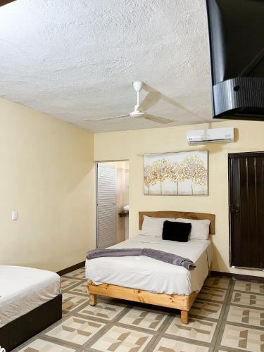 a bedroom with two beds and a ceiling at Casa Guiba 2 Puerto Escondido in Puerto Escondido