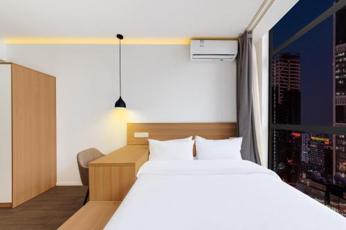 a hotel room with a bed and a window at Merica Hotel - Hangzhou Canal Branch in Hangzhou