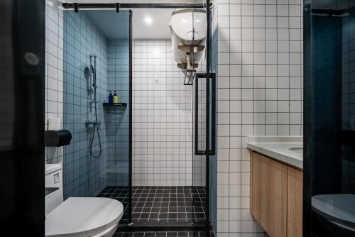 a bathroom with a shower with a toilet and a sink at Merica Hotel - Hangzhou Canal Branch in Hangzhou