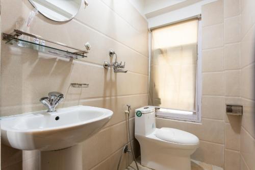 a bathroom with a sink and a toilet and a mirror at Thamel Hostel & Spa in Kathmandu