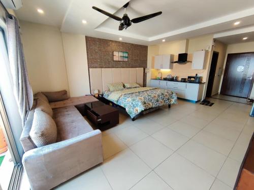 a bedroom with a bed and a couch in a room at Studio Murree facing apartment In Bahria Enclave in Islamabad