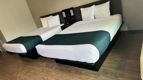 two beds sitting next to each other in a room at Studio 6 Corona, CA West in Corona