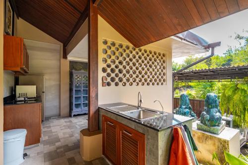an outdoor kitchen with a sink and a counter at Ocean Pearl Seaview Residence in Rawai Beach