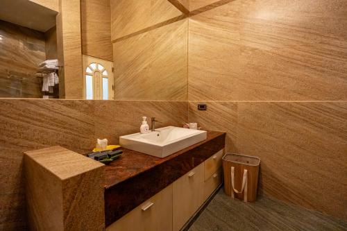 a bathroom with a white sink and a mirror at Ocean Pearl Seaview Residence in Rawai Beach
