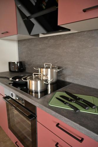 a kitchen with pots and pans on a stove at NEW Modern Apartment - 93m2 Central in Pfaffenhofen an der Ilm