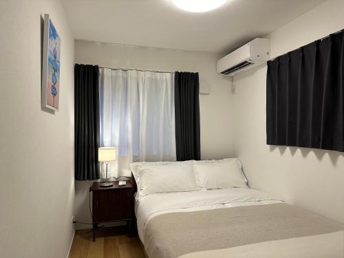 Ένα ή περισσότερα κρεβάτια σε δωμάτιο στο Oasis Omori New House - 30min to Haneda - 2 Adjacent Homes