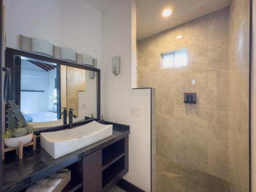 a bathroom with a white sink and a shower at La Gran Reserva in Los Santos