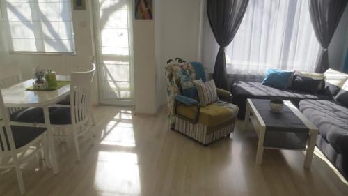 a living room with a couch and a table at Apartment Sophie in Plovdiv