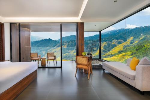 a bedroom with a bed and a view of mountains at Longji Skyreach Peak Resort - Golden Buddha Summit in Longsheng
