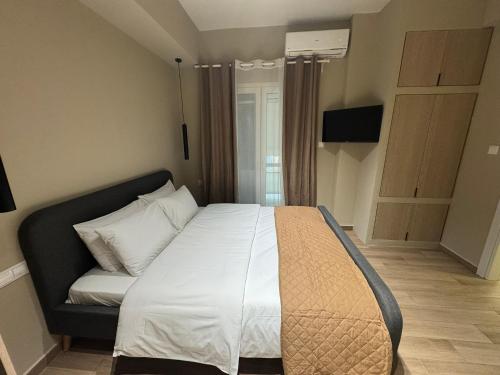 a bedroom with a bed and a couch at Artemis Apartments in Diakopto