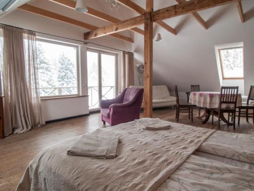 a bedroom with a bed and a table and chairs at Mokko Country Hotel in Palamuse