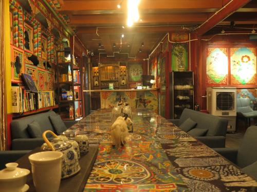 a dog standing on a long table in a room at 九寨沟碧家小筑民宿 Bijia Boutique B&B, jiuzhaigou in Tazang