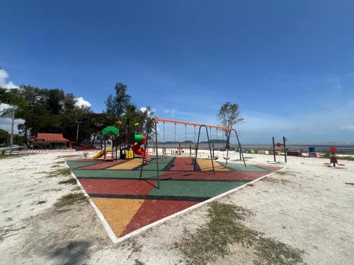 a group of playground equipment on a beach at SingBeach holiday house in Mersing