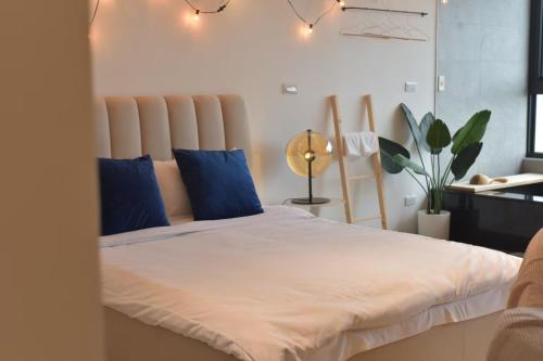 a bedroom with a large bed with blue pillows at 頭城 望嶼之家 海景溫泉民宿 Sea View & Hot Spring House in Toucheng