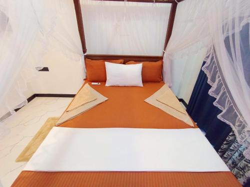 Ένα ή περισσότερα κρεβάτια σε δωμάτιο στο Vinu Home Stay