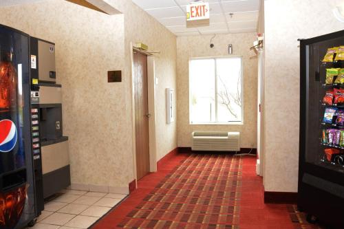 an empty hallway with a window in a room with aperature at Super 8 by Wyndham Corydon in Corydon