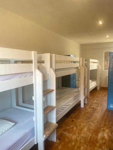 a group of bunk beds in a room at Las Hadas Albergue -solo para Peregrinos - Vegano -Bar in Reliegos