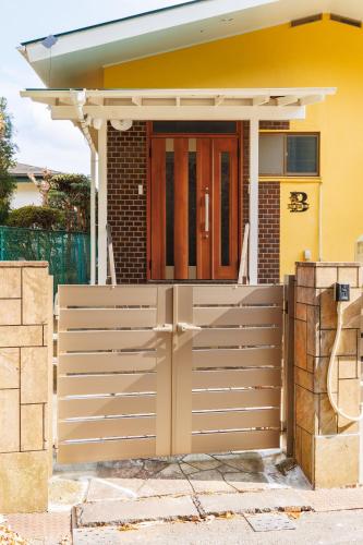 a gate in front of a house at blue moon blue in Ito