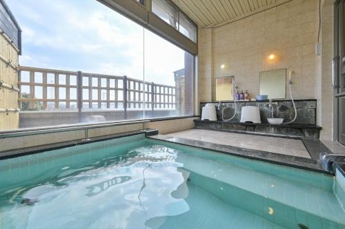a swimming pool with a view of a building at Kaikyo View SHIMONOSEKI - Vacation STAY 13685v in Shimonoseki