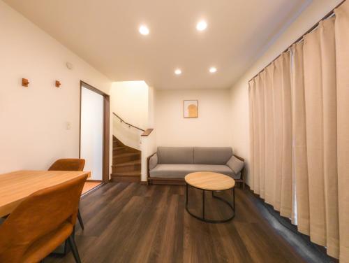 a living room with a couch and a table at japan house ヴィラ貸切東向島駅5分スカイツリー近く三号館 in Tokyo
