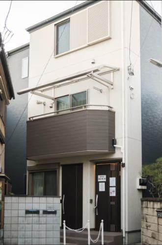 a white building with a balcony on the side of it at japan house ヴィラ貸切東向島駅5分スカイツリー近く三号館 in Tokyo
