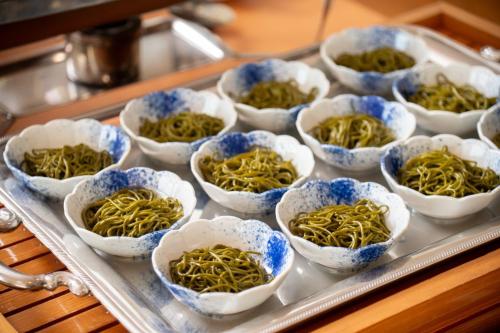 a tray of small bowls of food on a table at Kaikyo View SHIMONOSEKI - Vacation STAY 13687v in Shimonoseki