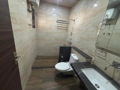 a bathroom with a white toilet and a sink at Khatu Bagh Resort in Sīkar