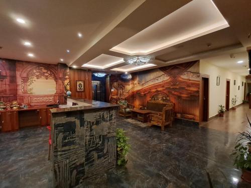 a large room with a wall with a painting on it at ARC The Boutique Hotel in Bhubaneshwar