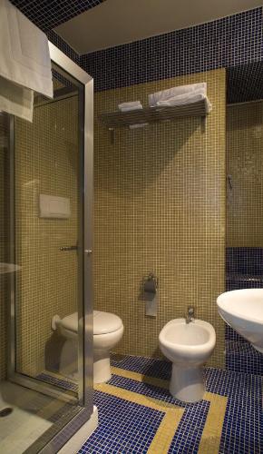 a bathroom with a toilet and a sink at Il Taschino Suite in Naples