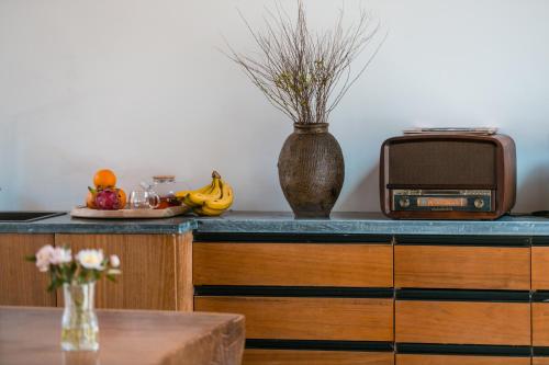 a kitchen with an old radio and a table at Yueyangli Garden Hotel in Baisha