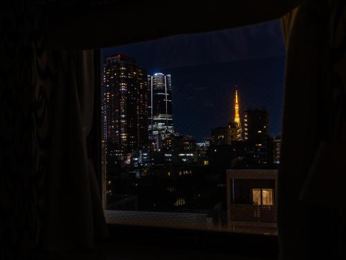 a view of a city skyline at night from a window at APA Hotel Nishiazabu in Tokyo