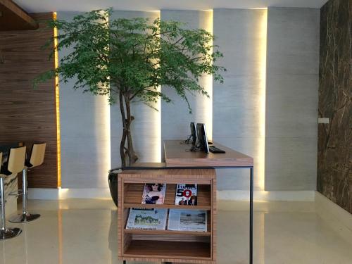 a tree sitting on top of a table in a room at Ayaka Suites in Jakarta