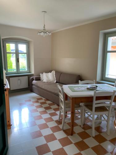 a living room with a table and a couch at Agriturismo Maso Giomo in Brentonico