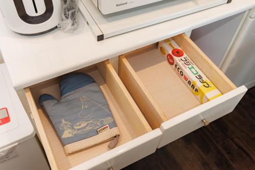 a drawer in a refrigerator filled with kitchen utensils at blue moon blue in Ito