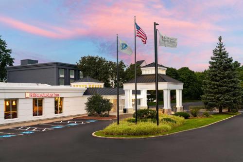 a rendering of the front of a building with two flags at Hilton Garden Inn Boston-Burlington in Burlington