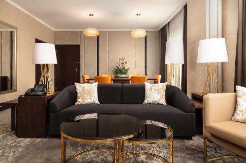 a living room with a couch and a table at DoubleTree by Hilton Łódź in Łódź
