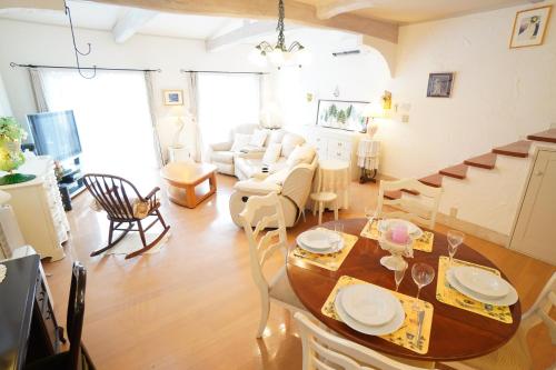 a living room with a table and a couch at karuizawa villa Baum in miyota in Miyota