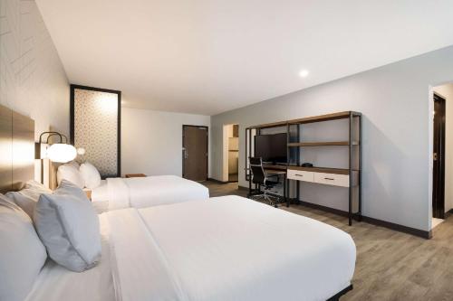 Postel nebo postele na pokoji v ubytování Everhome Suites Corona