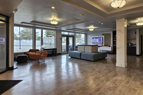 a lobby with a couch and chairs in a building at Edgewater Inn and Suites, an Ascend Collection Hotel in Coos Bay