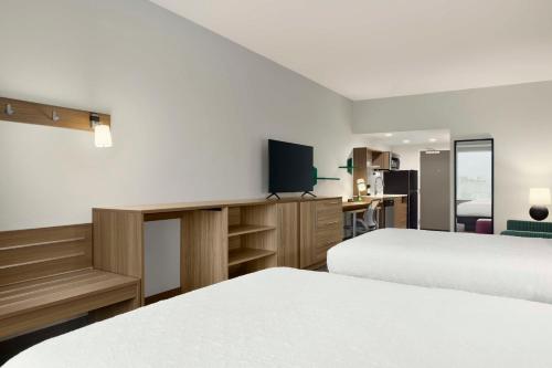 a hotel room with two beds and a tv at Home2 Suites By Hilton San Juan in San Juan