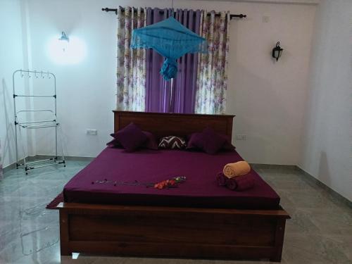 a bedroom with a bed with purple sheets at Sunrise Relax Inn in Beruwala