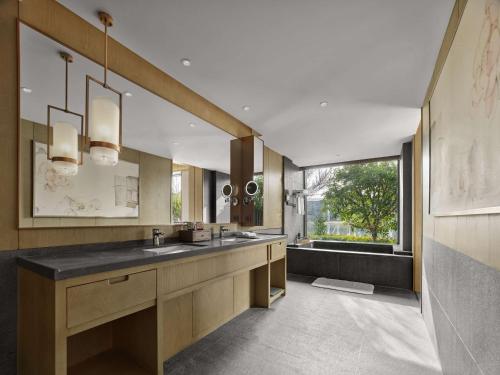 a large bathroom with a sink and a window at Hilton Suzhou New District in Suzhou