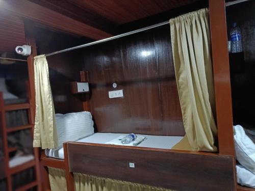 a mirror in a room with a sink at ASRA DORMITORY For Male And Female in Mumbai