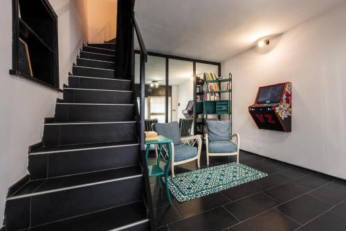 a staircase with two chairs and a table in a room at Appartamento La Bottega del Sarto in Palestrina