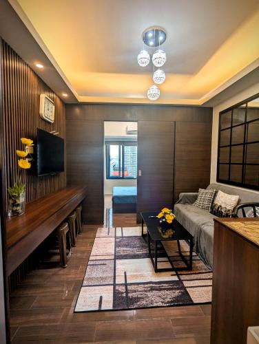 a living room with a couch and a table at 1 bedroom Cozy Escape in Manila