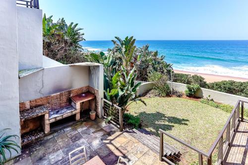 a view of the beach from the balcony of a house at La Pirogue 1 in Westbrook
