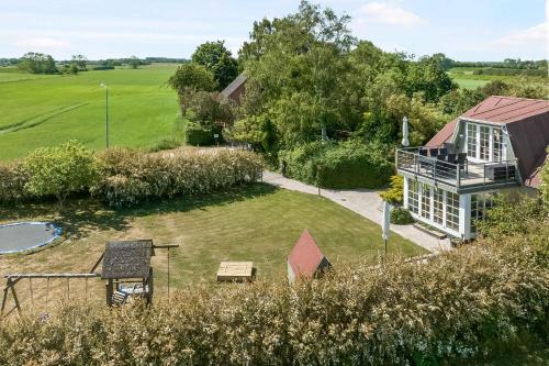 an aerial view of a house with a yard at Child-Friendly Cottage With Large Indoor Pool in Otterup