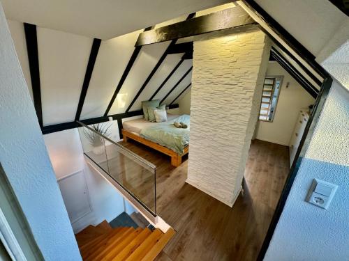 an overhead view of a room with a bed and a brick wall at Gemütliches Häuschen im Ortskern von Hohentengen am Hochrhein in Hohentengen